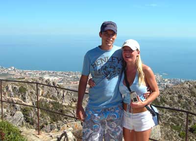 A young couple on the top of Calamoro Mountain with Benamadena Marina near the girls shoulder, and Toromolinos on the extreme left. The mountain top is accessable by cable car